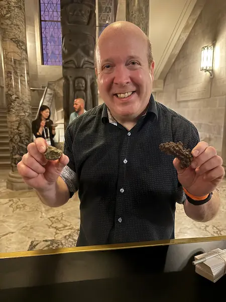 Ian Stewart holding fossilized dinosaur dung at the Royal Ontario Museum in Toronto