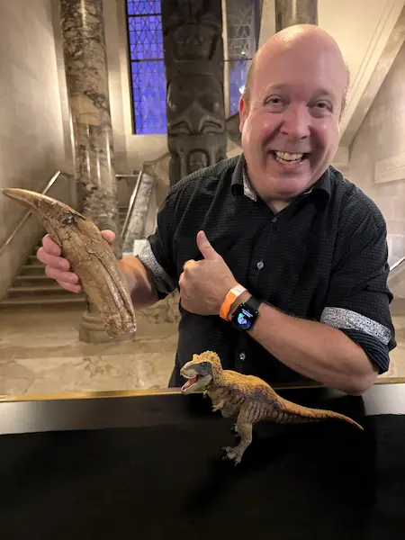 World Record Magician Ian Stewart holding a real Tyrannosaurus rex tooth at the Royal Ontario Museum