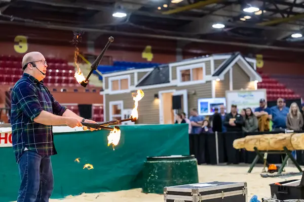 Ian Stewart juggling three flaming torches during a Guinness World Record attempt